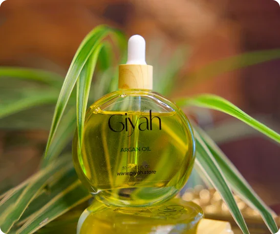 Giyah argan oil bottle with dropper on green leaves, natural skincare product